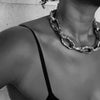 Black and white photo showing a close-up of a person wearing an Aji XL heavy chain necklace.