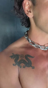 A man wearing the Aji XL men's chunky chain necklace around his neck, with a visible dragon tattoo near his shoulder.