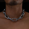 Close-up of a man wearing the Aji XL men's thick chain in sterling silver, featuring chunky, textured links around his neck.