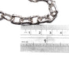 Close-up of the Ula chunky chain beside a ruler measuring in centimeters and inches to display the size of the chain links.