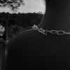 Black and white image showing the back of a person's neck, with part of the Ula sterling silver thick chain visible along the shoulder.