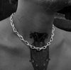 Man wearing the Ula thick chain necklace around his neck, with visible tattoos on his neck and chest, displayed in a black and white photo.