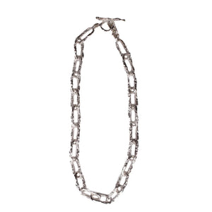 Ula X thick chain necklace with large, rugged silver links in an open circular design, displayed on a plain white background.