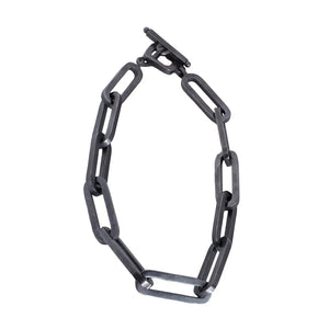 XL black chain necklace with large rectangular links and a toggle clasp, arranged in a loose loop against a white background.