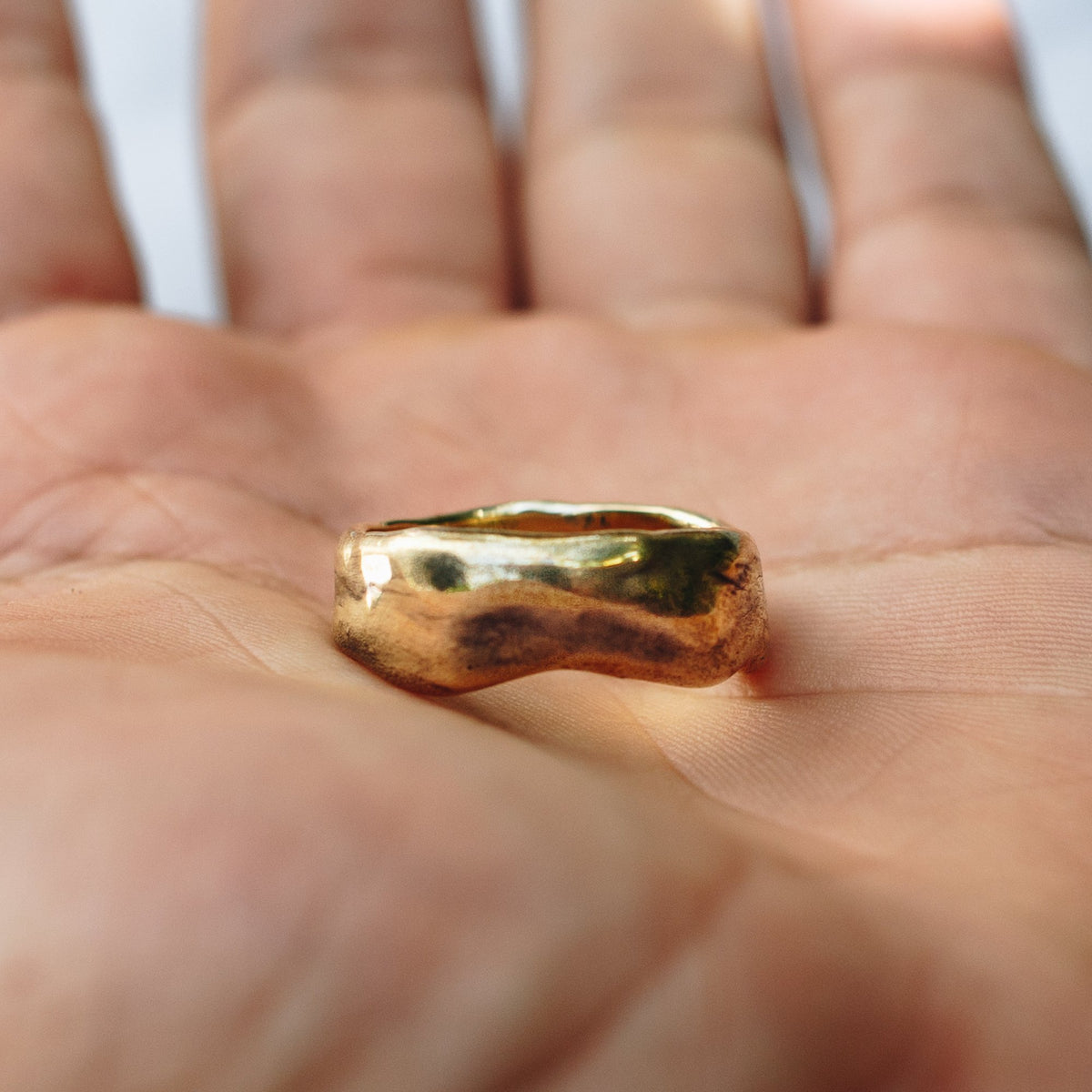 JewelryLab Medium Uja brass ring with an irregular sculptural shape resting on an open palm